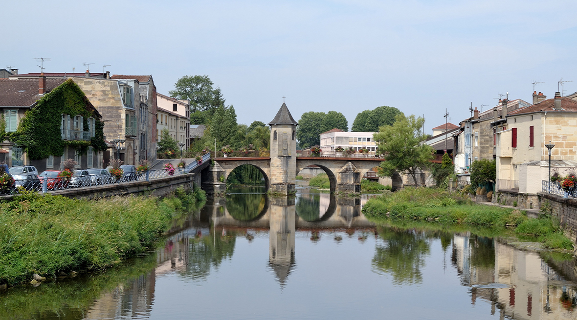 Picturesque French town with bridge over canal water